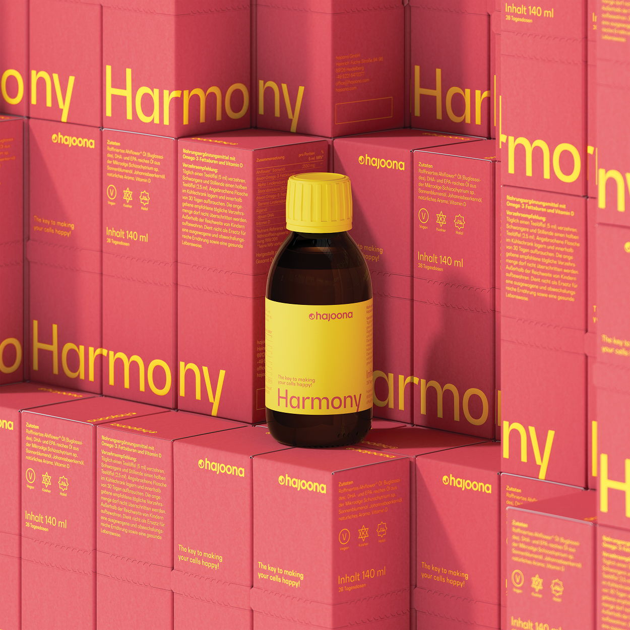 Braune Glasflasche mit gelbem Etikett und gelbem Schraubverschluss – hajoona Harmony. Davor und dahinter stapeln sich mehrere peach-gelbe Produktverpackungen. Die Aufschrift: ‚The key to making your cells happy.‘ Die Inhaltsstoffe unterstützen unter anderem Zellgesundheit und Gelenke.